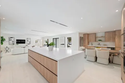 a large white kitchen with a large window