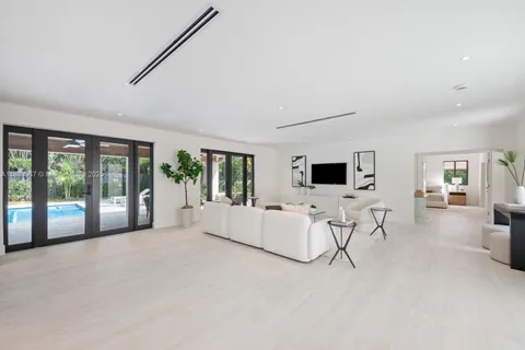 a living room with furniture and large windows