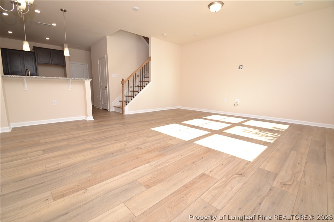 5703 Preveza Place Raleigh, NC 27603 - Photo 2 of 33 a view of empty room with wooden floor