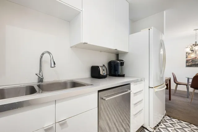 a kitchen with a refrigerator and cabinets