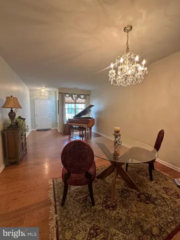 a view of a dining room with furniture and chandelier