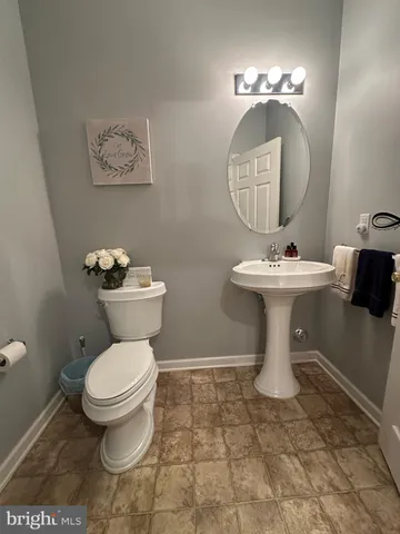 a white toilet sitting next to a bathroom sink