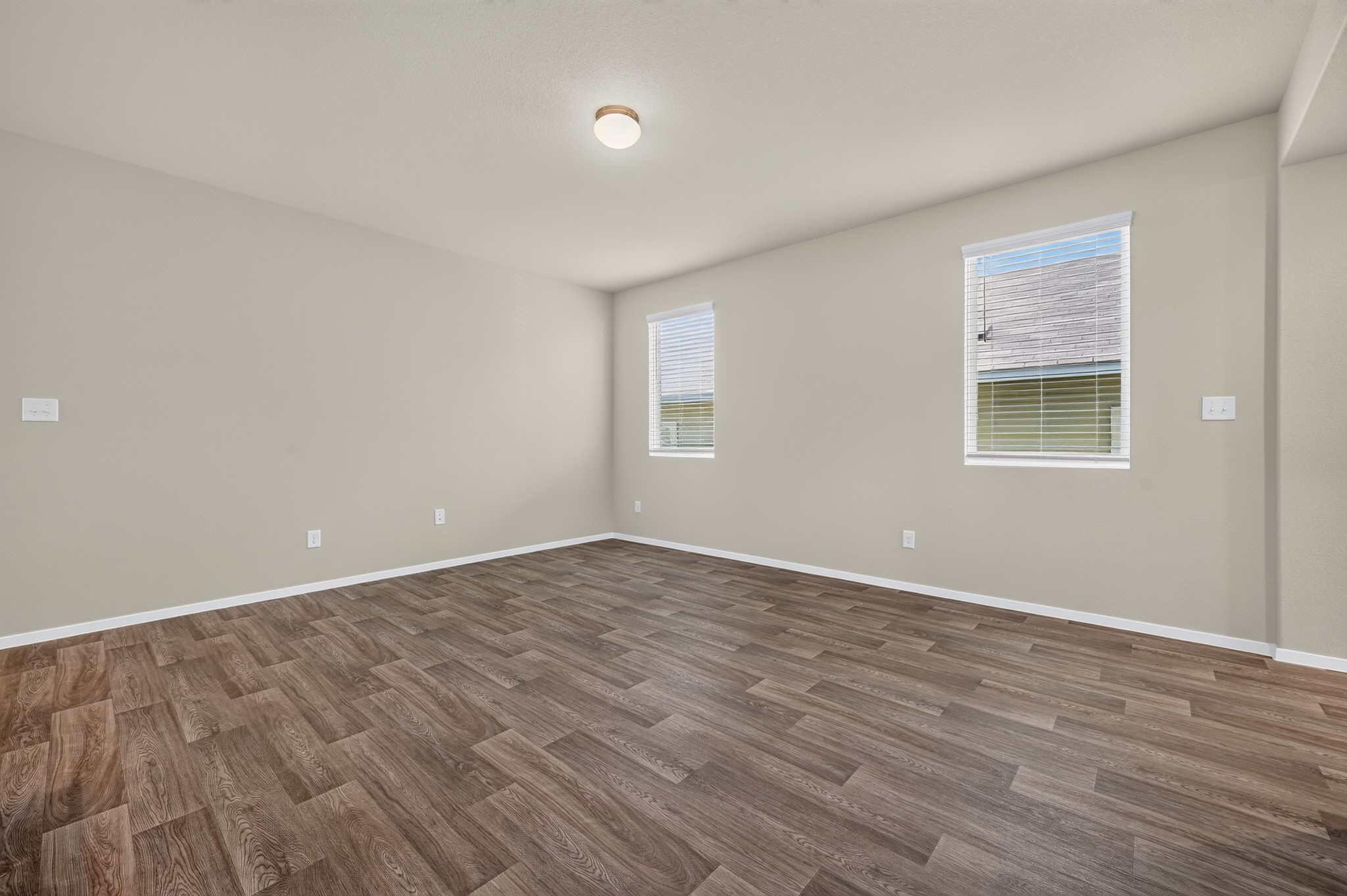 2704 Towy Road Manor, TX 78653 - Photo 27 of 36 Rich wood-look flooring and dual windows define this versatile, open living area.