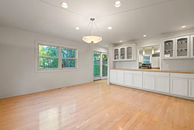 a view of empty room with a window and fireplace