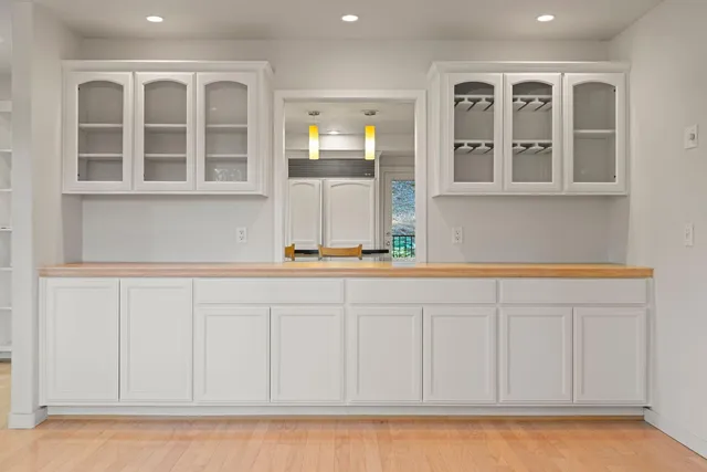 a kitchen with a refrigerator and a stove top oven