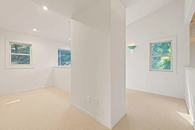 a spacious bathroom with a granite countertop tub sink and window