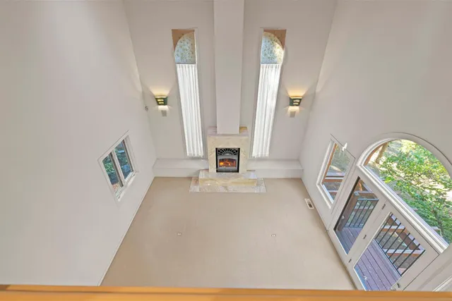 a large white bathroom with a granite countertop sink mirror and a large window