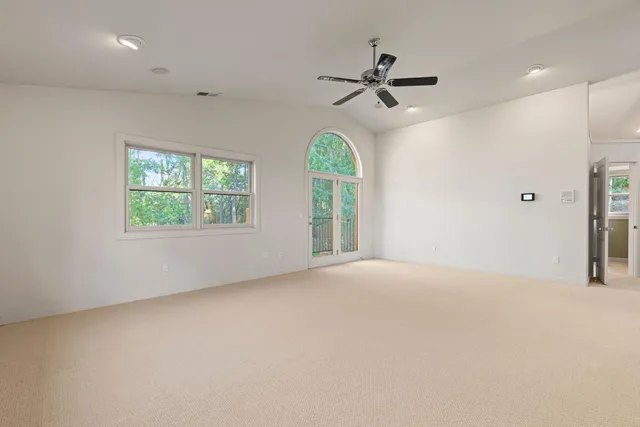 a bathroom with a granite countertop sink a toilet a mirror and shower