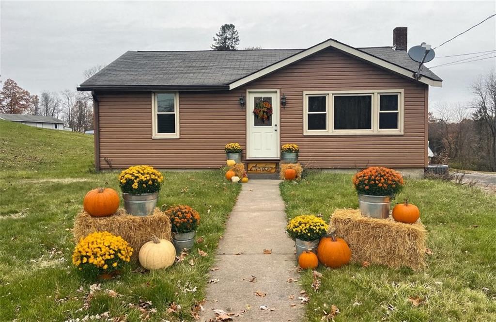 1339 Freeport Road Kittanning, PA 16201 - Photo 1 of 25 a view of a backyard with table and chairs and potted plants