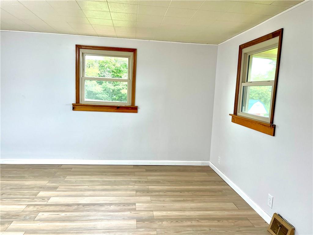 1339 Freeport Road Kittanning, PA 16201 - Photo 13 of 25 a view of an empty room with wooden floor and a window