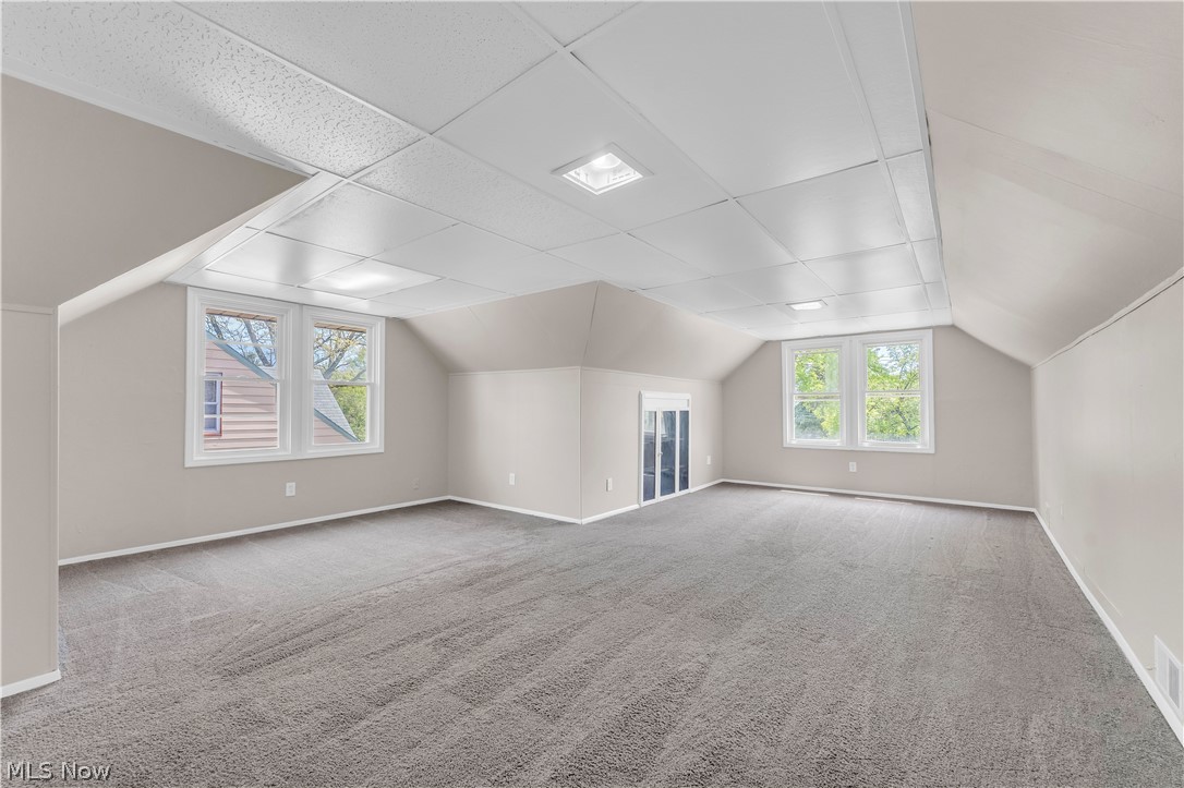 18123 McCracken Road Maple Heights, OH 44137 - Photo 20 of 27 Spacious room with gray textured carpeting, neutral wall tones, and a white acoustical tile ceiling