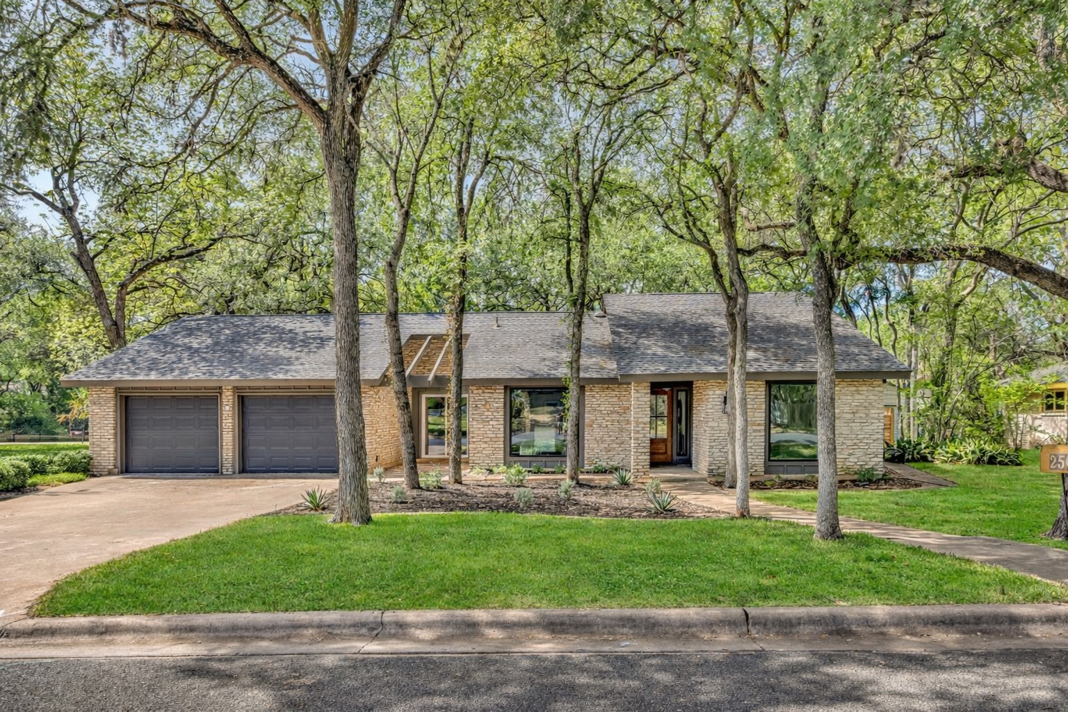 2501 Crownspoint Drive Austin, TX 78748 - Photo 1 of 1 a front view of a house with a garden and tree