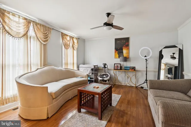 a living room with furniture a window and a chandelier