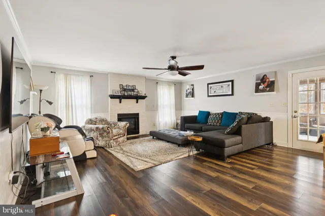 a living room with furniture a fireplace and a window