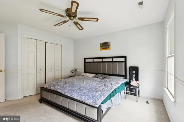 a bedroom with a bed and window