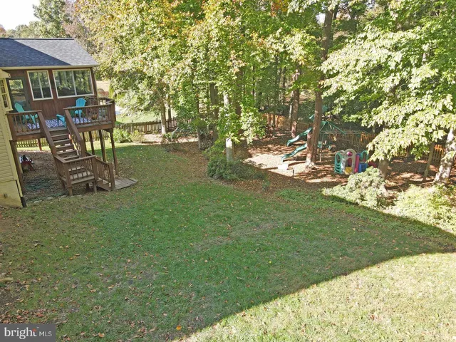 a view of patio with table and chairs and garden