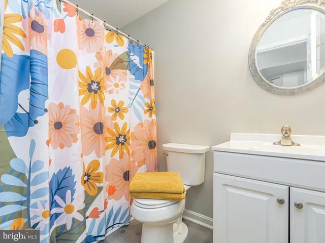 a bathroom with a sink and mirror with toilet