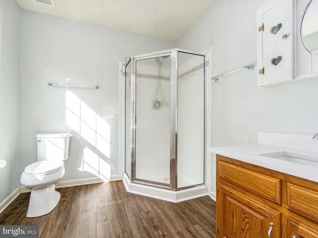 a bathroom with a toilet and a shower