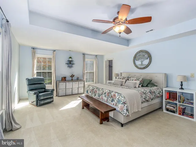 a bedroom with a bed a chandelier and a chandelier