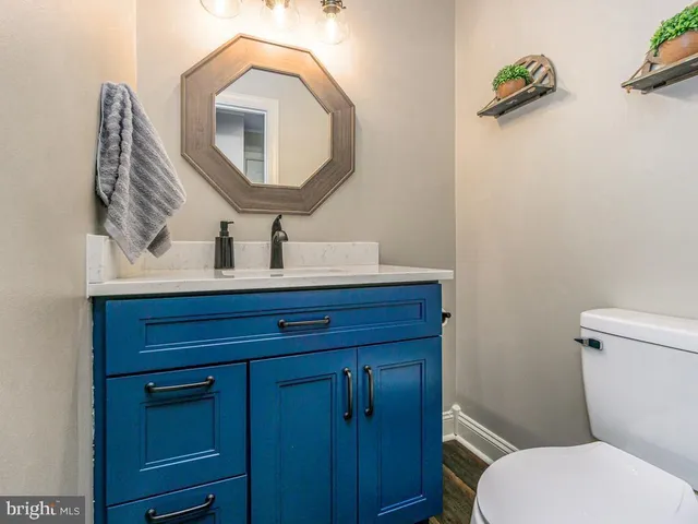 a bathroom with a toilet sink and mirror