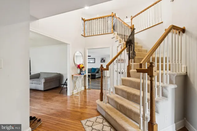 a view of entryway and hall with wooden floor