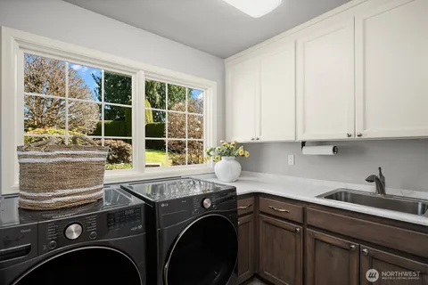 a view of a kitchen with sink dryer and washer