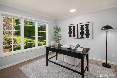 a view of a workspace with furniture and window