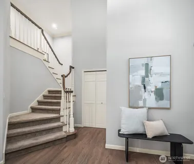 a view of entryway and hall with wooden floor