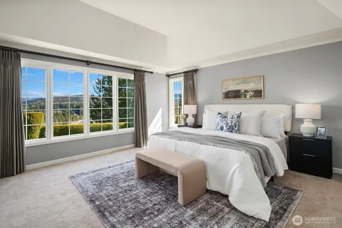 a spacious bedroom with a large bed and a large window