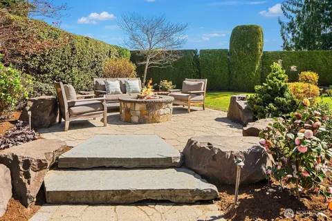 a view of swimming pool with outdoor seating and plants