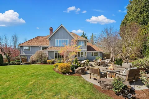 a view of a house with a big yard and sitting area