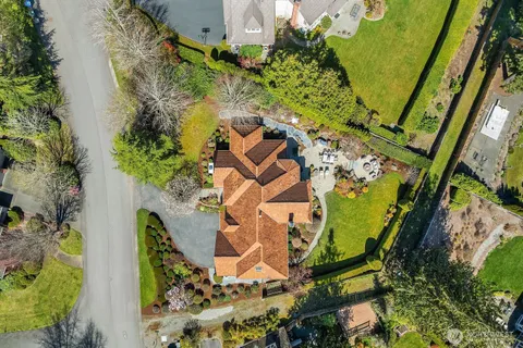 an aerial view of a house with a yard and garden