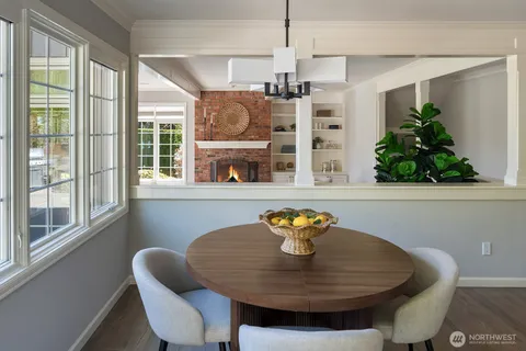 a view of a dining room with furniture a chandelier and wooden floor