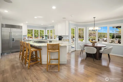 a large kitchen with a table and chairs