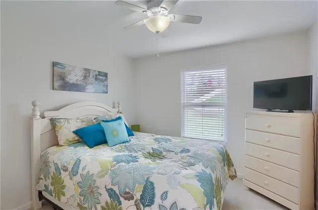 a bedroom with a large bed and a flat screen tv