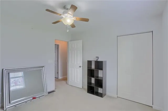 a view of a livingroom with a chandelier fan