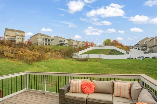 a view of a roof deck with furniture