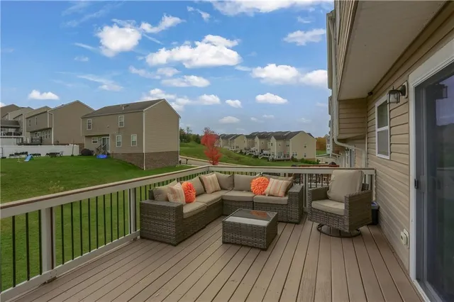 a view of roof deck with couches and wooden floor