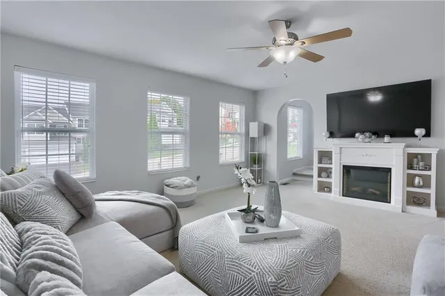 a living room with fireplace furniture and a flat screen tv