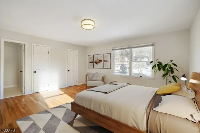 a bedroom with a bed and a large window