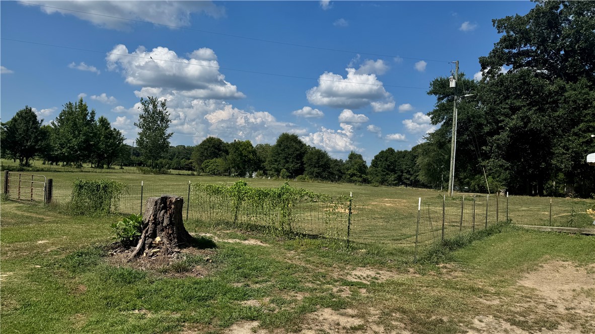 101 Due West Road Belton, SC 29627 - Photo 20 of 22 Green pastures and wooded areas define this tranquil, open-air lot, offering serene natural surroundings.