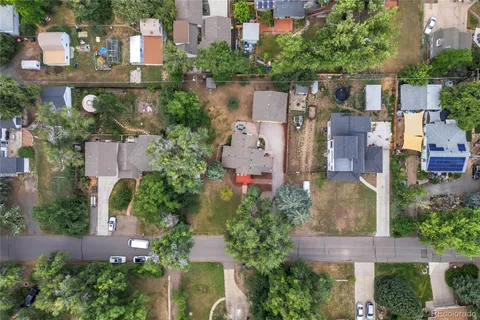 an aerial view of a house with a yard and mountain view in back