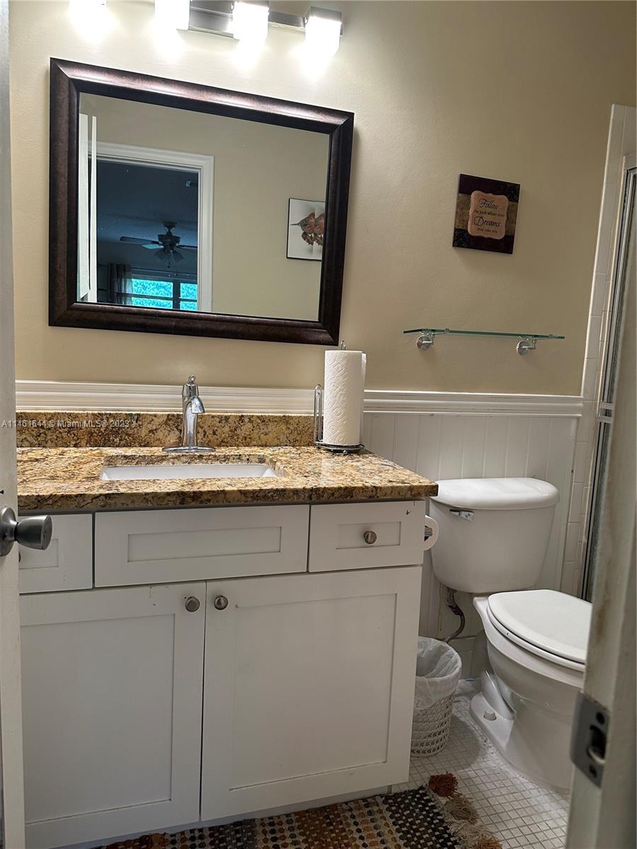14711 Edna Way Delray Beach, FL 33484 - Photo 11 of 23 a bathroom with a toilet sink and mirror