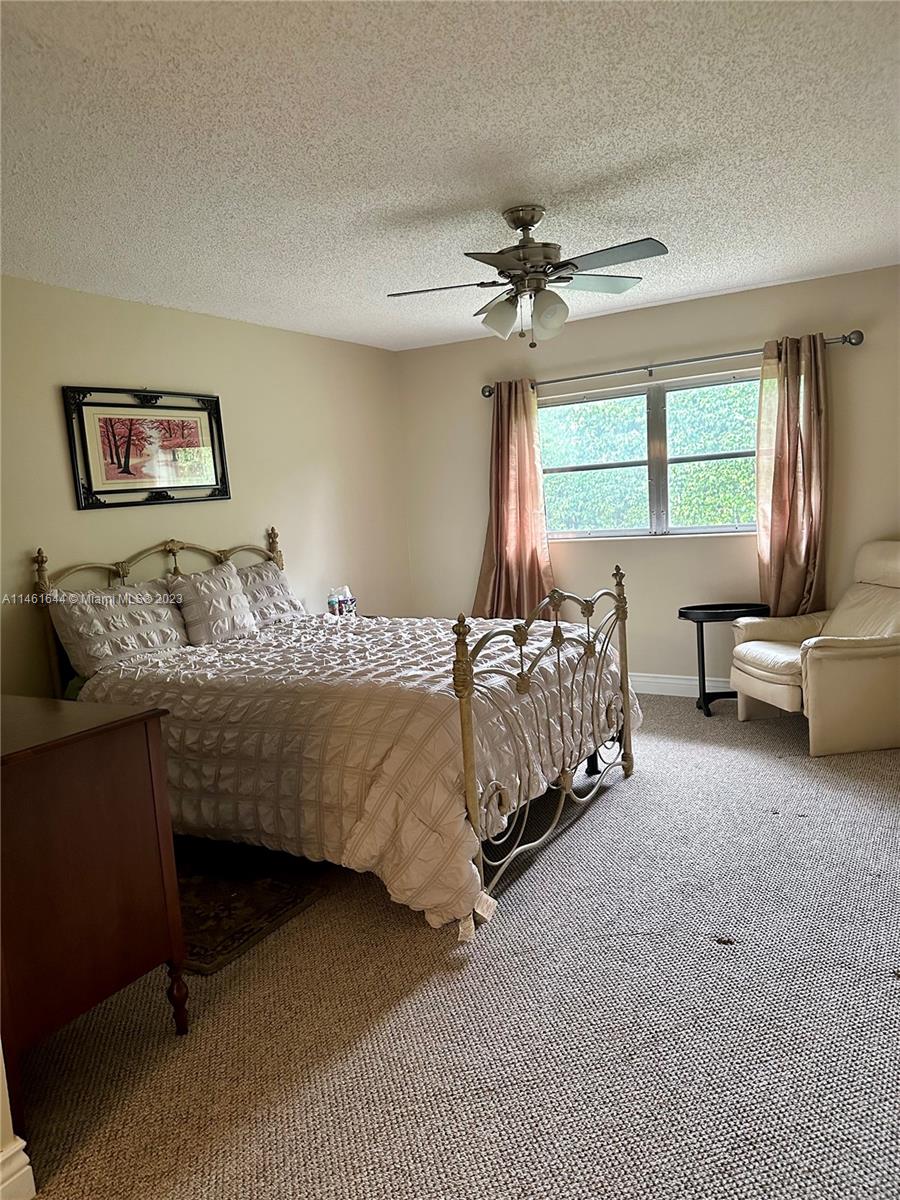 14711 Edna Way Delray Beach, FL 33484 - Photo 12 of 23 a bedroom with a bed and a window