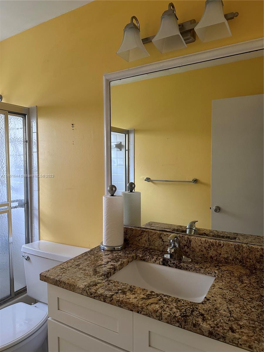 14711 Edna Way Delray Beach, FL 33484 - Photo 13 of 23 a bathroom with a granite countertop sink and a mirror