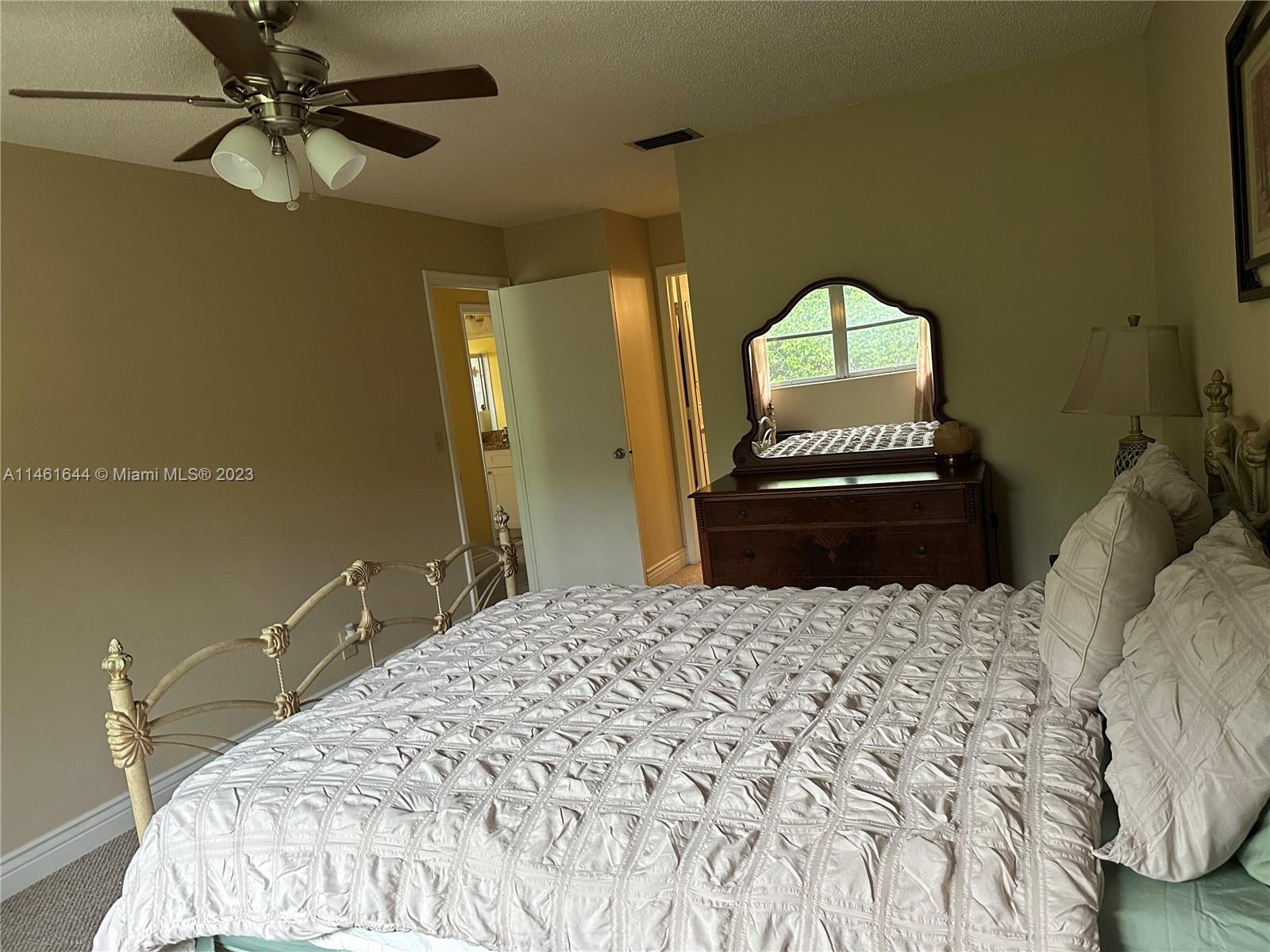 14711 Edna Way Delray Beach, FL 33484 - Photo 14 of 23 a bedroom with a bed and a dresser