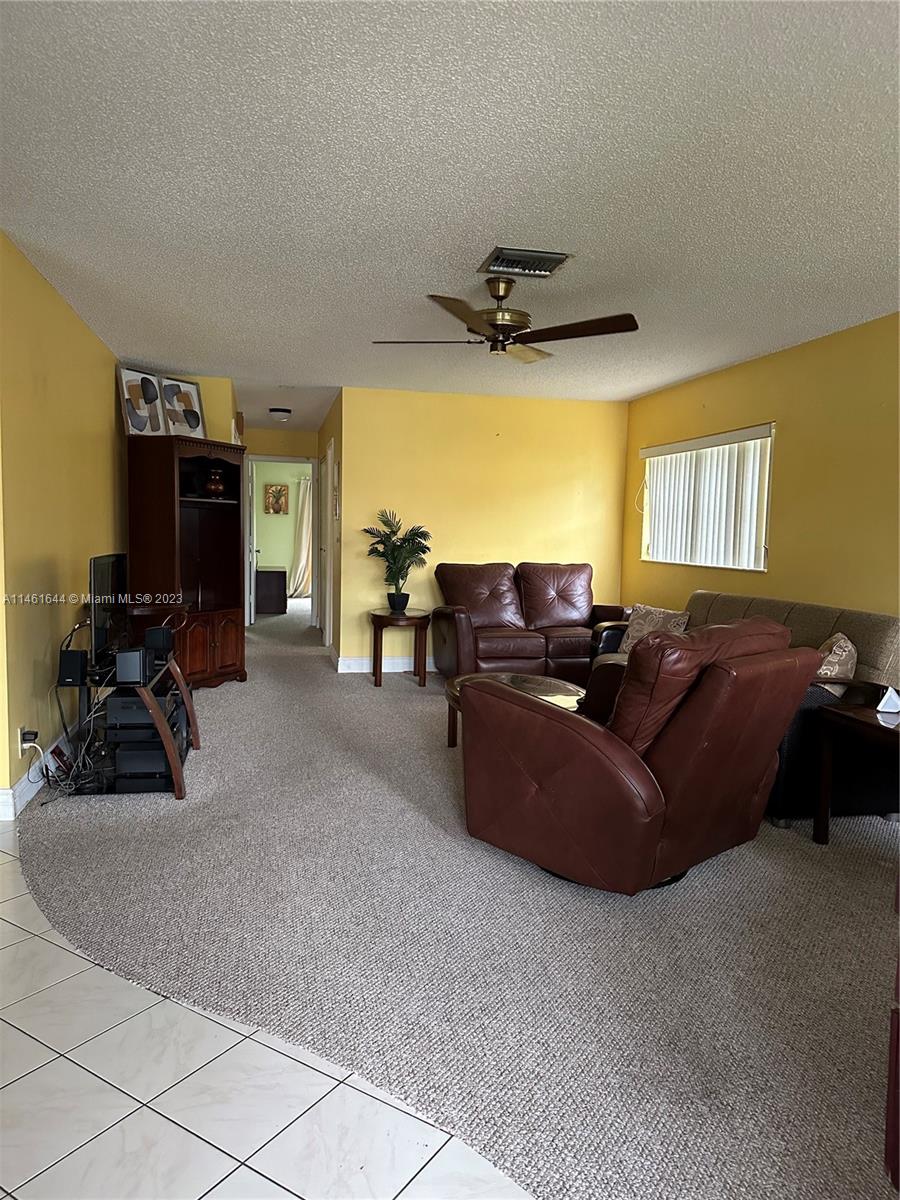 14711 Edna Way Delray Beach, FL 33484 - Photo 15 of 23 a living room with furniture and a flat screen tv