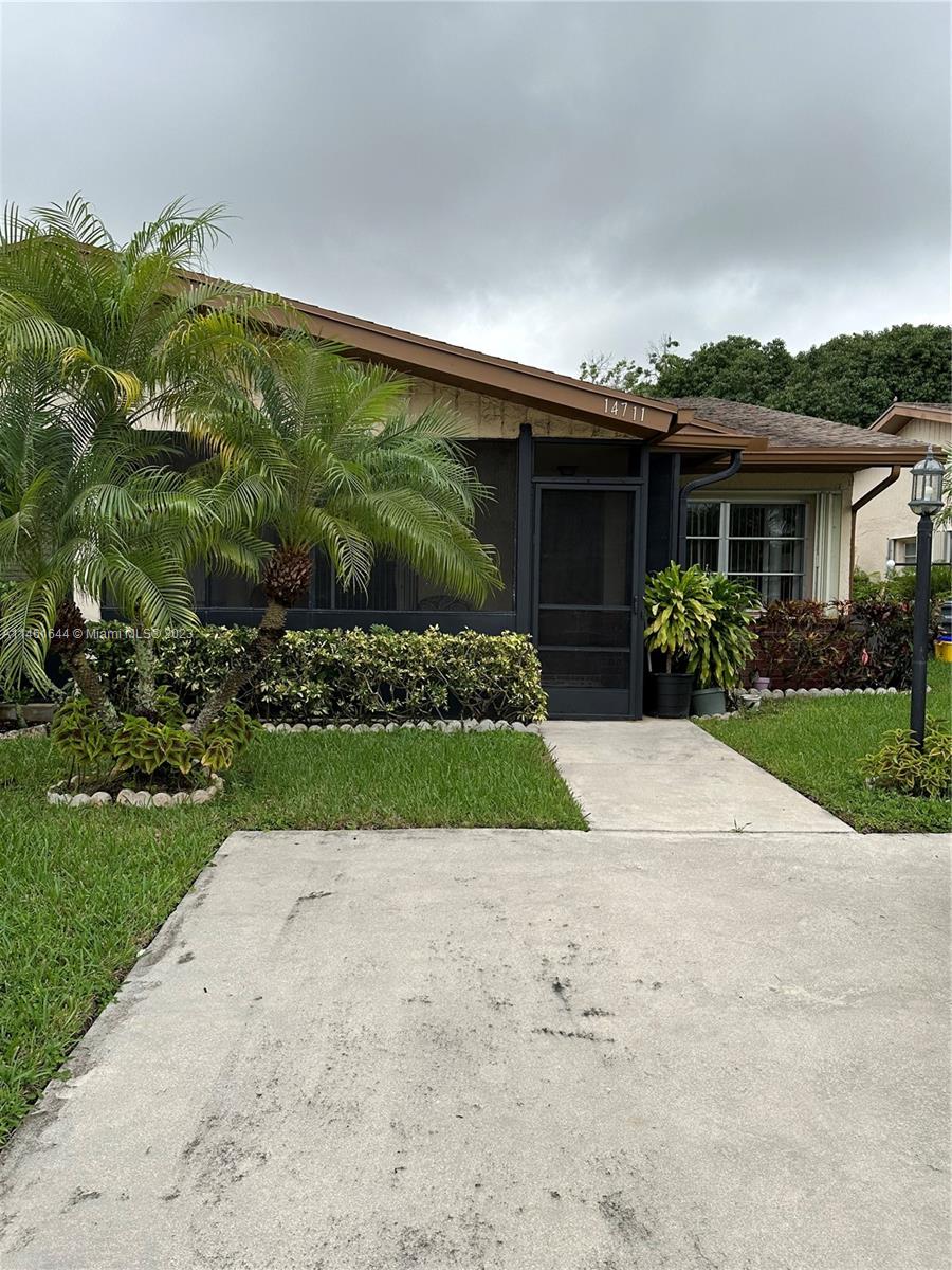 14711 Edna Way Delray Beach, FL 33484 - Photo 22 of 23 a front view of house with yard and green space