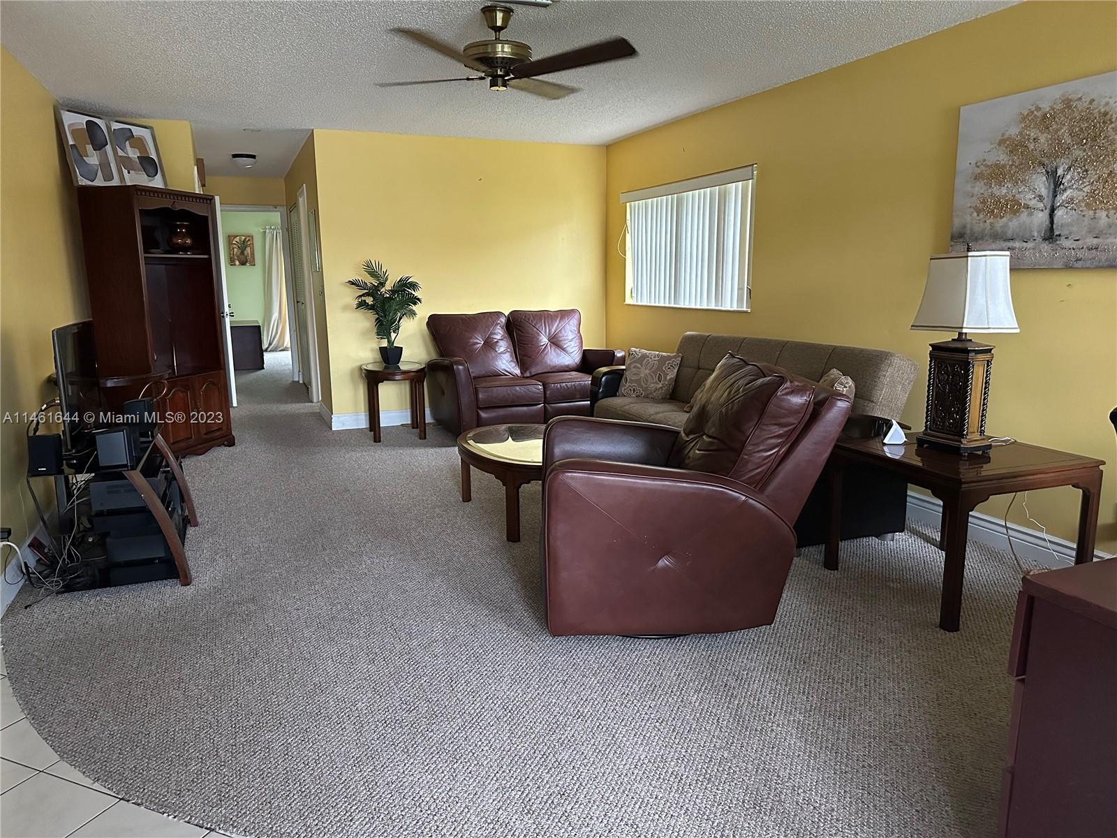 14711 Edna Way Delray Beach, FL 33484 - Photo 3 of 23 a living room with furniture and a flat screen tv