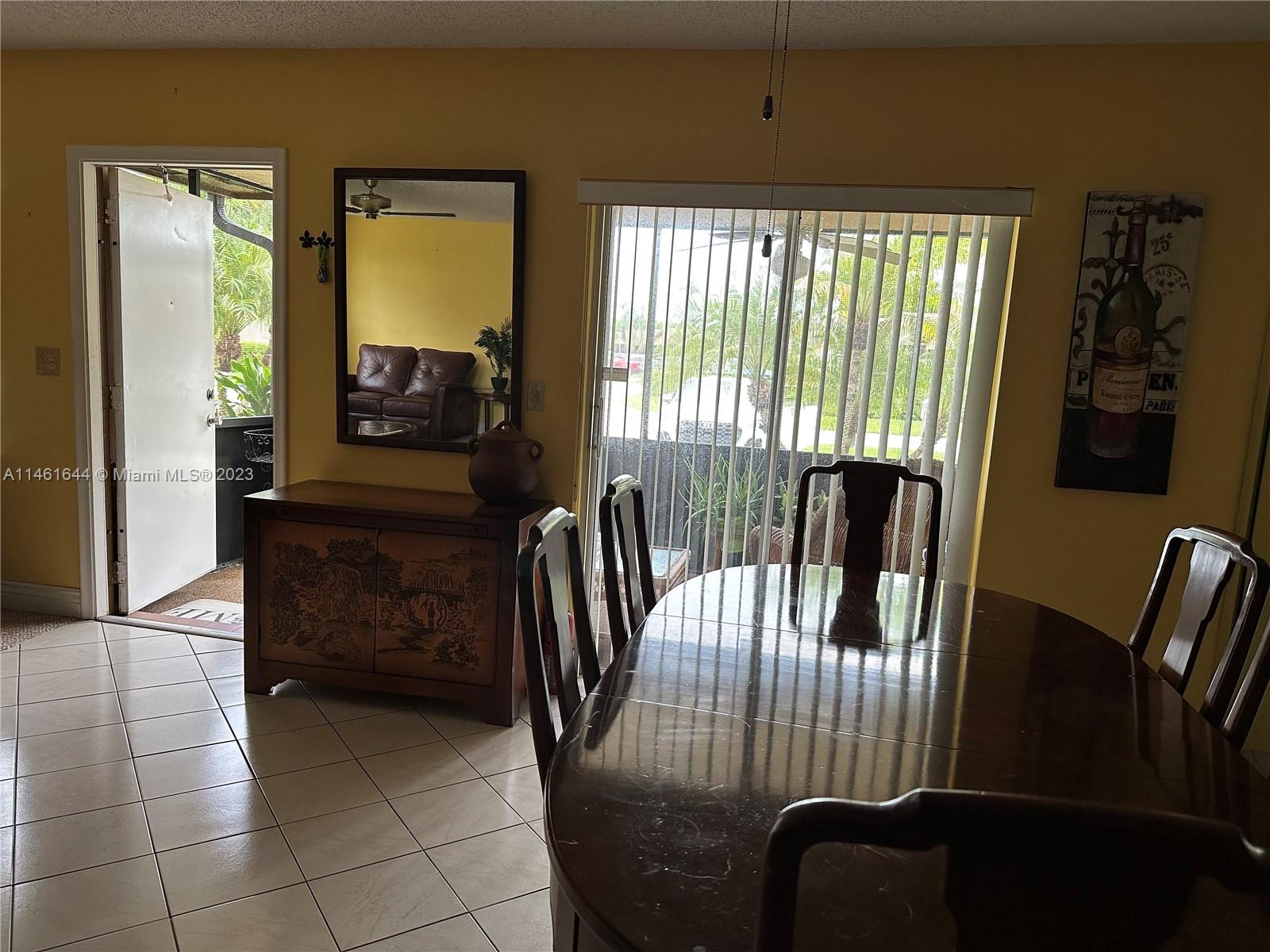 14711 Edna Way Delray Beach, FL 33484 - Photo 7 of 23 a view of a dining room with furniture and a window